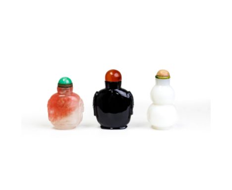 Three Chinese glass snuff bottlesLate Qing dynastyComprising: a white glass imitating jade double gourd bottle, associated ha