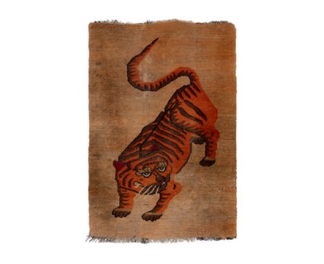 A Tibetan 'Tiger' rug19th century134cm x 89cm.Provenance: collection of Mimi Lipton, purchased directly from the collector (b