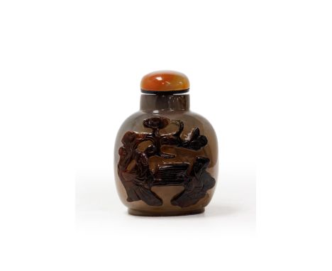 A large Chinese carved agate 'scholars' snuff bottleLate Qing dynastyThe well-hollowed bottle carved from a semi-translucent 