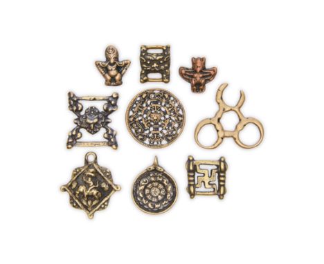 Nine Tibetan copper and copper-alloy talismans, amulets and scripture buckles, thokcha16th-18th/19th centuryComprising: one i