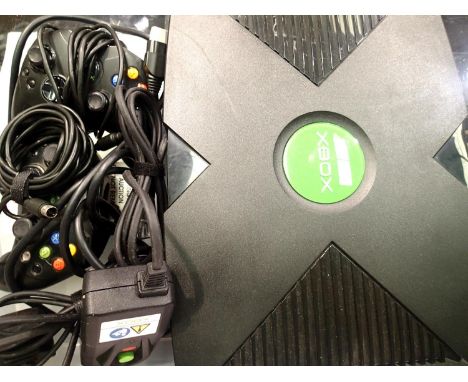 Microsoft Xbox games console with power supply and two controllers. P&amp;P Group 3 (£25+VAT for the first lot and £5+VAT for