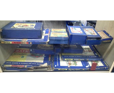 Thirteen Bayko set boxes containing quantity of parts, books etc. Contents of sets unchecked and boxes are poor. P&amp;P Grou