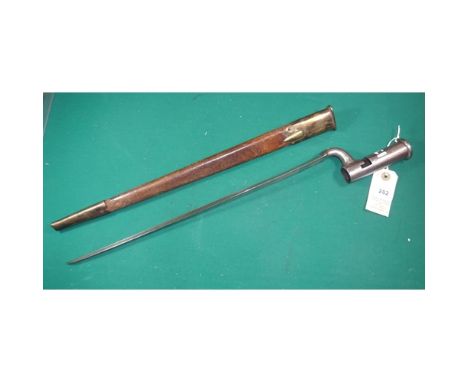 A Brown Bess triangular socket bayonet with 4" socket and unmarked 15¼" blade, in its brass mounted brown leather scabbard. G