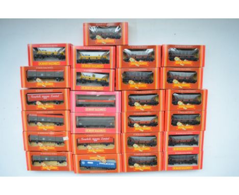 Twenty five boxed Hornby OO gauge goods wagons to include curtain sided vans, open wagons, closed vans and Hopper wagons. Mos