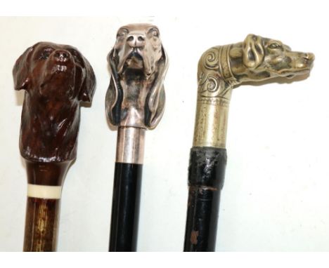 Ebonised walking stick with cast Hounds head handle, another similar and a stick with carved wooden Labrador handle stamped G