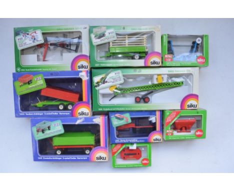 Nine boxed 1/32 tractor accessories by Siku to include 2x 2-axled Trailers, Deutz Hay Rake, Elevator with 2 Hay Bales, Live-S