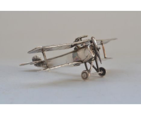 Sterling silver biplane model, most likely a Nieuport 17, stamped with 925 underside. Weight 53.1g, wingspan 9.1cm 