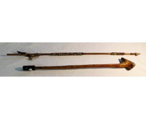 African ceremonial arrow with stone arrowhead and beadwork decoration and feather fletching, ceremonial club carved with bear