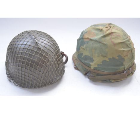 US Army Vietnam era M1 steel helmet with liner and chinstrap and a repainted hard plastic Belgian riot police helmet dated 19