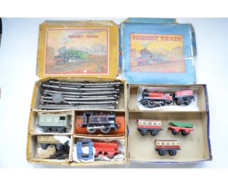 Two boxed vintage Hornby clockwork train sets to include 2x 0-4-0 locos, BR black Type 40 (in working order) and Red 3435 (no