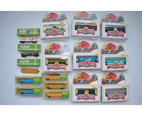 Sixteen boxed N gauge American freight wagons, 8 by Bachmann, 8 by Minitrix. Some after purchase weathering added but all at 