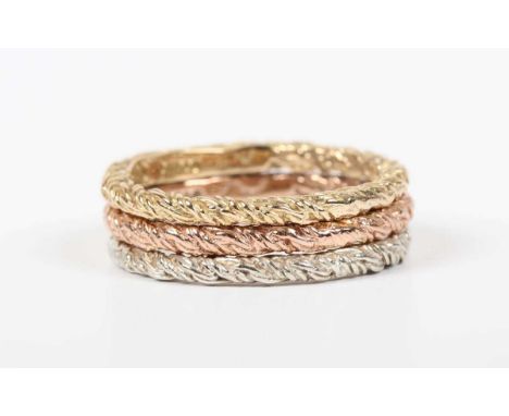 A set of three 9ct yellow, rose and white gold stacking rings, each in a textured design, Birmingham 1976, weight 5.5g, ring 