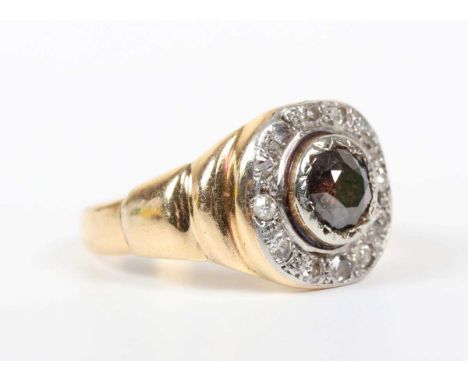 A gold and diamond cluster ring, mounted with a circular cut greenish brown diamond within a surround of variously cut diamon
