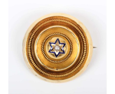 A late Victorian gold, seed pearl and blue enamelled circular brooch, the centre gypsy set with a seed pearl within a star sh