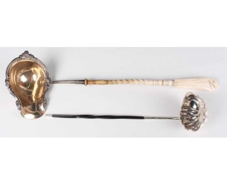 A Continental silver punch ladle, the oval bowl with scroll embossed rim, fitted with a carved bone handle detailed with init