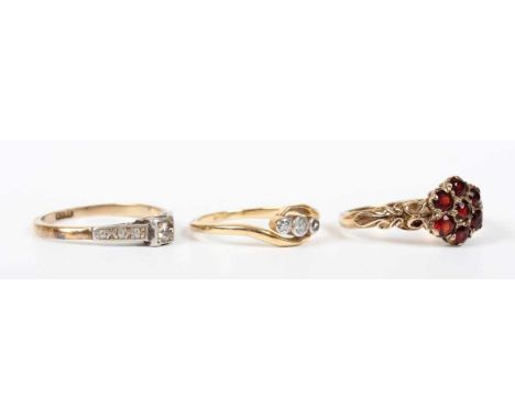 A gold and diamond three stone ring in a crossover design, detailed ‘18ct’, ring size approx L, a gold and diamond single sto