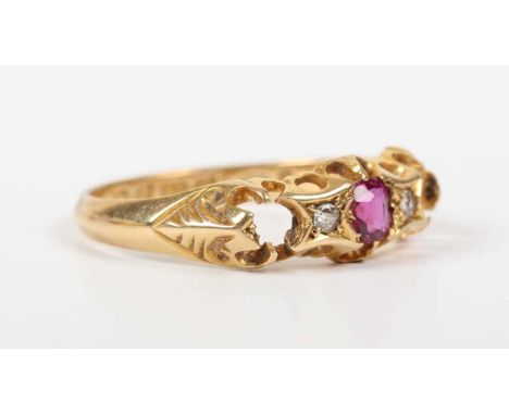 An Edwardian 18ct gold ring, mounted with an oval cut ruby between two old cut cushion shaped diamonds, Chester 1903, weight 