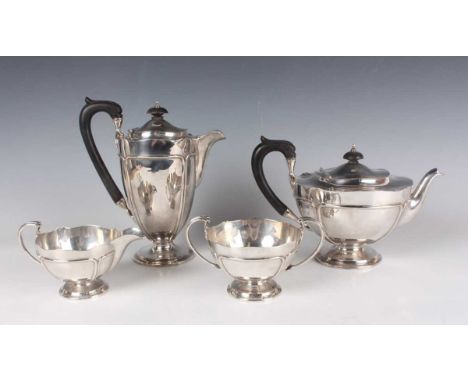A George V silver matched four-piece tea set of circular form with reeded panels, on a circular foot, comprising teapot, milk