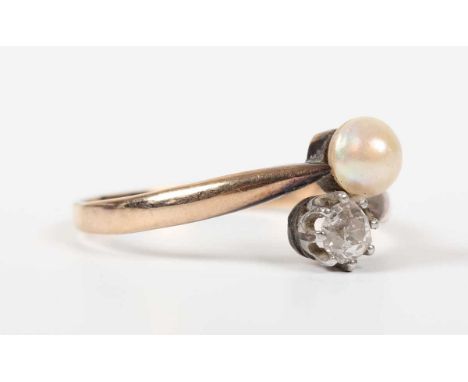 A gold, diamond and half-pearl ring in a crossover design, unmarked, weight 2.1g, ring size approx P1/2.