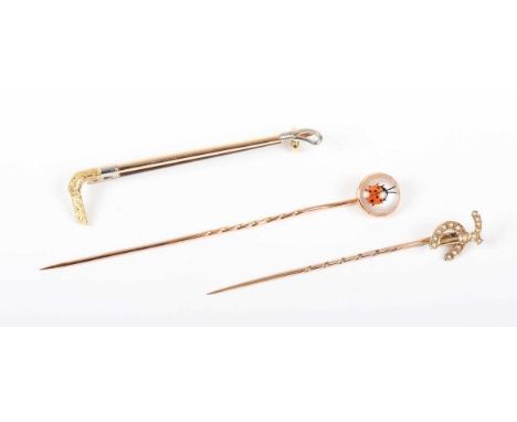 A gold and reverse painted intaglio crystal stickpin, designed as a ladybird, detailed ‘9ct’, weight 1.2g, diameter of finial