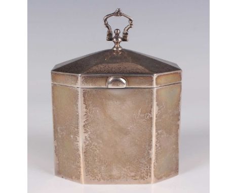 An Edwardian silver tea caddy of canted corner rectangular form, the slightly domed hinged lid with hinged scroll handle, Lon