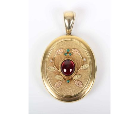 A gold, garnet, turquoise and seed pearl oval pendant locket, the front collet set with an oval cabochon garnet within a foli