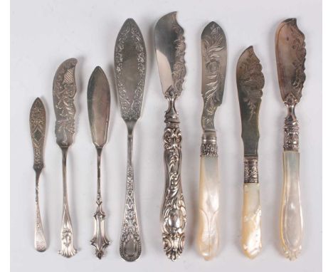 Three Victorian silver and mother-of-pearl handled butter knives, each with engraved decoration, comprising Sheffield 1854, S