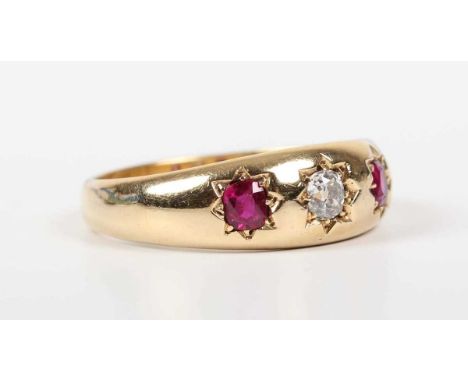 A gold, ruby and diamond ring, star gypsy set with an old cut cushion shaped diamond between two cushion shaped rubies, detai