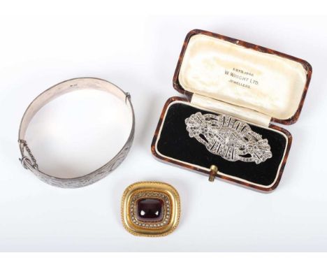 A gold mounted, carbuncle garnet and seed pearl curved rectangular brooch, decorated with a bead and wirework border, the bac