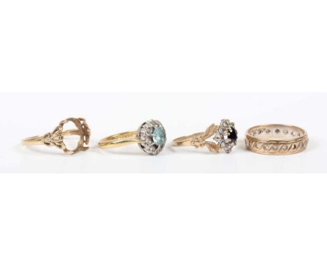 An 18ct gold, blue zircon and diamond cluster ring, claw set with a circular cut blue zircon within a surround of single cut 
