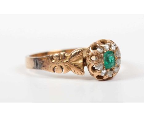 A gold, emerald and diamond cluster ring, the central emerald within a rose cut diamond surround, unmarked, weight 3.2g, ring