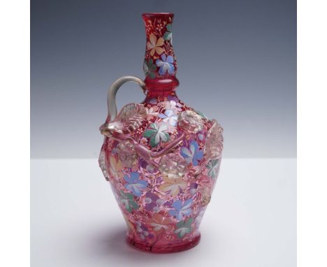 A richly decorated Moser glass ewer in vibrant cranberry red, showcasing hand-enameled pastel floral designs throughout the b