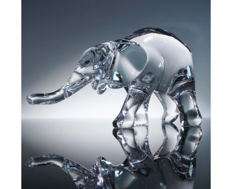 Finely crafted Baccarat clear crystal figurine depicting an elephant in a walking pose, capturing the gentle curves and power