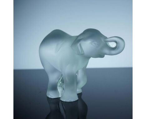 Crafted in frosted crystal, this Lalique elephant figurine presents the gentle majesty of the animal with its trunk playfully