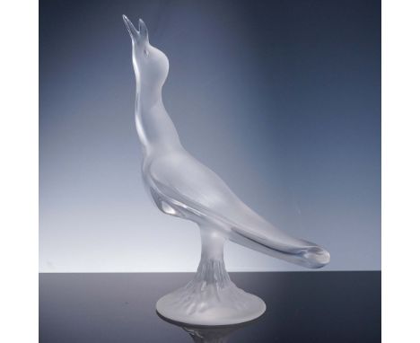 Presented is a captivating Lalique crystal figurine depicting a stylized seagull in song. With its wings gently folded and he