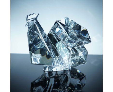 This striking Baccarat crystal rooster features bold geometric facets that reflect and refract light beautifully, capturing t