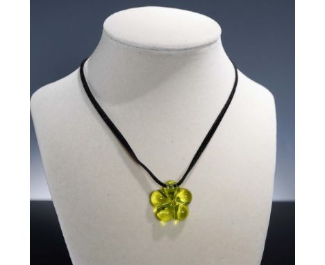 Elegant Baccarat Lili choker featuring an olivine green crystal flower pendant suspended on a sleek black cord. The floral de