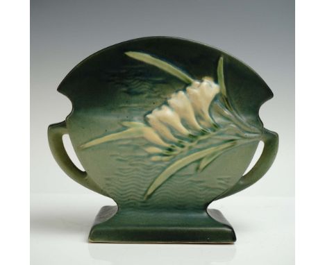 Roseville Pottery fan-shaped vase in the Freesia pattern, finished in green with dual sculpted floral motifs on each side - o