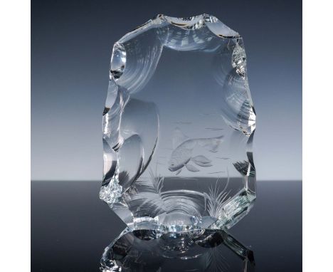 A limited edition, clear crystal sculpture featuring a deeply etched koi fish swimming among aquatic plants, rendered within 