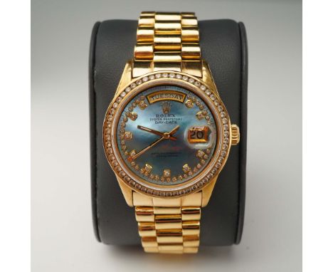 This luxurious Rolex President Oyster Perpetual Day-Date wristwatch is crafted in 18K yellow gold and exemplifies the iconic 