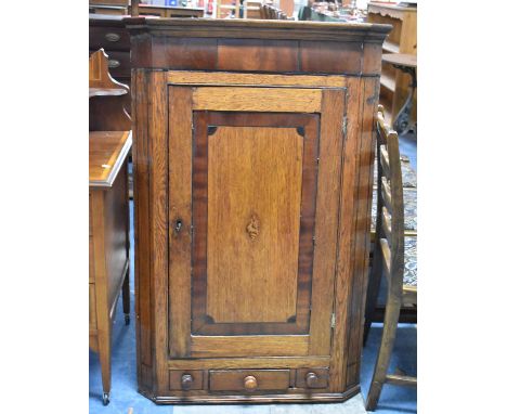 A 19th Century Oak and Mahogany Wall Hanging Corner Cabinet with Base Drawer and Shelf Inlay to Panelled Door, 76cm wide 