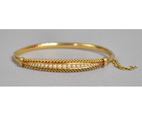 A Late Victorian Gold Metal Hinged Bangle with 21 Split Pearls Set in Etruscan Revival Mount, Having Additional Safety Chain.