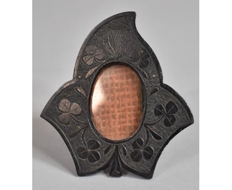A Small Easel Back Irish Bog Oak Photo Frame in the Form of Leaf with Shamrock and Harp Carved Decoration, 7cm high 