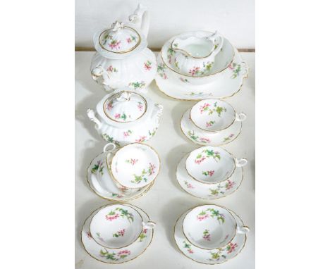 A COALPORT MOULDED TEA SERVICE, PRINTED AND PAINTED WITH STYLISED FLOWERS AND SPRIGS, THE CUPS OF ADELAIDE SHAPE, TEAPOT AND 