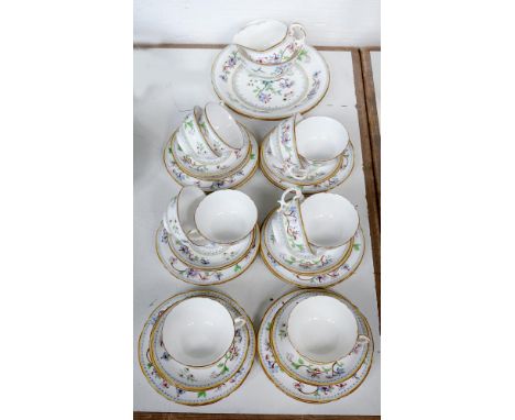 A ROYAL WORCESTER TEA SERVICE, PRINTED AND PAINTED WITH CHINESE FLOWERS, RIMS GILT, PUCE PRINTED MARK, EARLY 20TH C