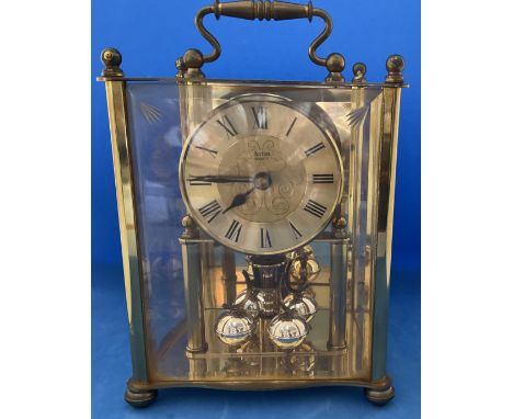 Actium Quartz mantle clock with carrying handle. Made in Germany. Brass and glass. 7 inches in height appx. Good condition. W