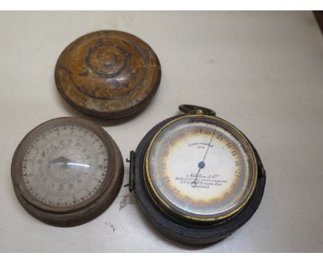 A Norton &amp; Co pocket barometer in part case and a compass in treen box - Width 5.5cm 