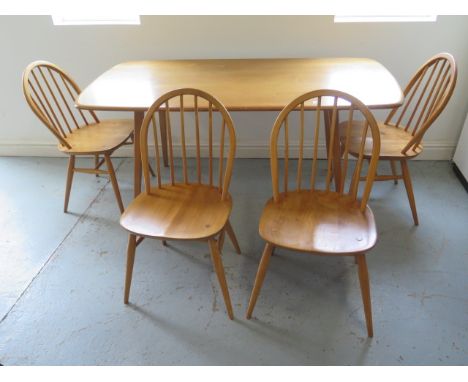 An Ercol blonde elm dining table with four stick back chairs - Table 71cm tall x 152cm, Chairs 82cm tall - some small usage m