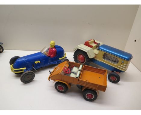 A Gama tinplate battery operated tractor - Length 22cm - a plastic clockwork racing car, a tinplate clockwork UNIMOG 