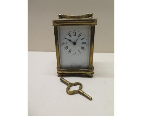 A brass carriage clock - Height 13cm - running with key 